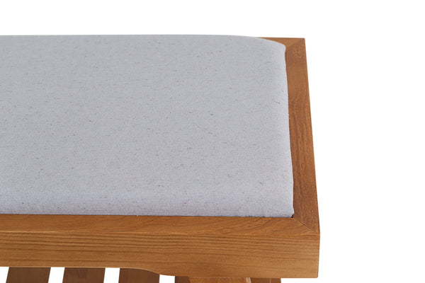 foto do banco para mesa de jantar de madeira 2 lugares éden na cor nozes e tecido cinza claro focando no tecido do assento em fundo branco